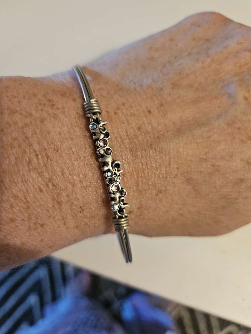 Delicate Silver-Tone Floral Accent Bangle with Multicolor Stones